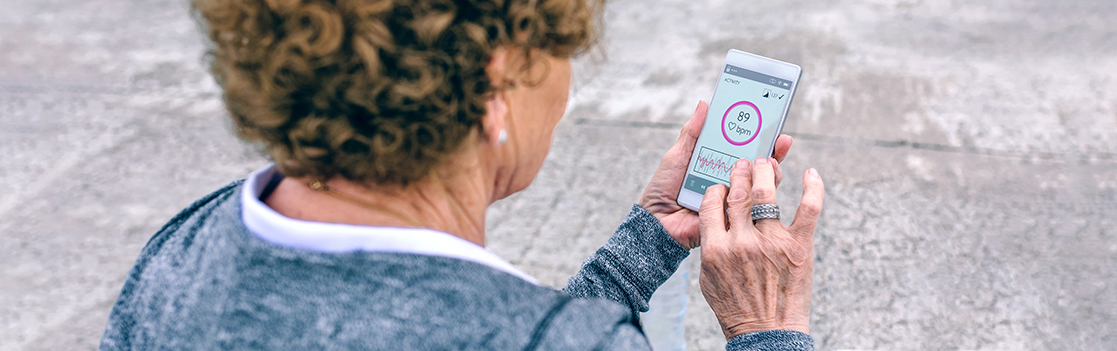 Back view of senior woman using smartphone